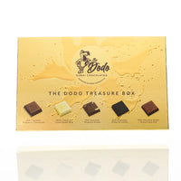 Dodo Dubai Chocolates Treasure Box packaging with chocolate pieces on a yellow background